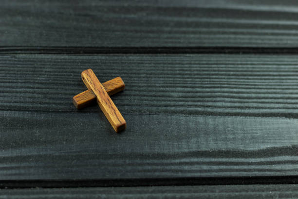 istock wooden cross on a dark wooden surface 1149046814