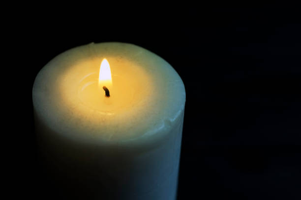 istock burning candle in the dark 1149046835