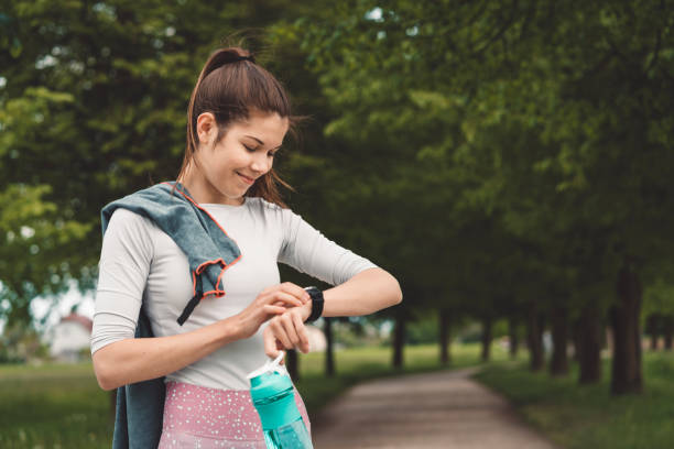 istock Smiling happy woman checking her time after 10k run 1149050233