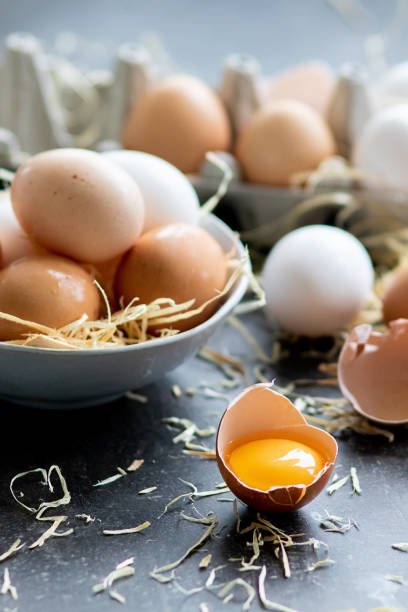 istock Fresh organic raw eggs, white, beige and brown, one is cracked 1149051545