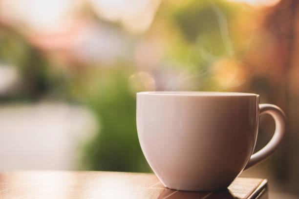 hot coffee cup with smoke in the morning hot coffee cup with smoke in the morning with nature sunlight background tea hot drink stock pictures, royalty-free photos & images