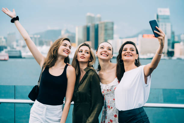 istock Girlfriends enjoying vacations in Hong Kong, taking selfie 1149054376