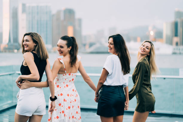 istock Young women standing on bridge, rear view 1149054384