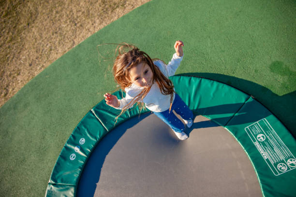 istock Young Girl Jumping on Trampoline 1149054524