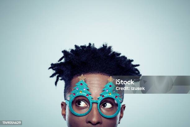 African Man With Christmas Mask Stock Photo - Download Image Now - Christmas, Humor, Eyeglasses