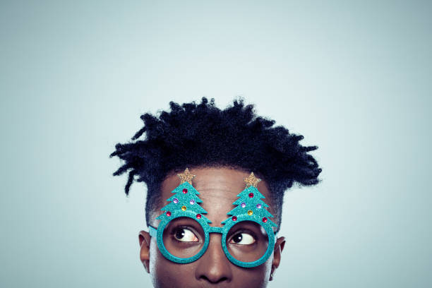 африканец в рождественской маске - thinking men glasses studio shot стоковые фото и изображения