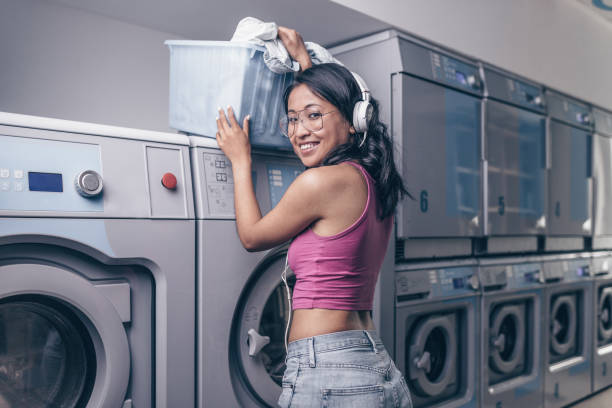 istock Attractive girl with a basket in the laundry 1149055900