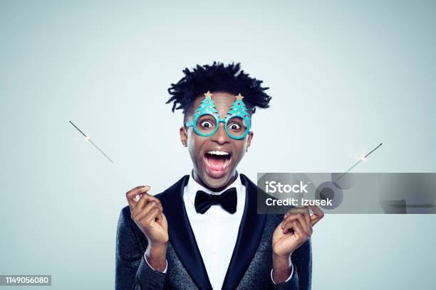 Funny Christmas Portrait Of Man With Sparklers Stock Photo - Download Image Now - Men, Party - Social Event, Firework Display