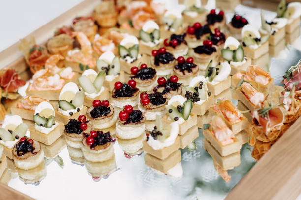 istock Different canapes with salmon, cucumber, berries and eggs served on a table 1149056094