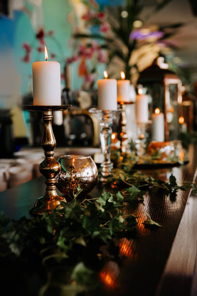 istock Romantic table setting decorated with burning candles and green ivy leaves. 1149056324