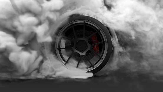 Tire Burnout. Burning rubber and Smoking tire with a rotating wheel with thick Smoke on dark background.