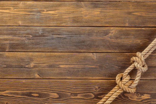 istock Rope knot on wooden board 1149061753