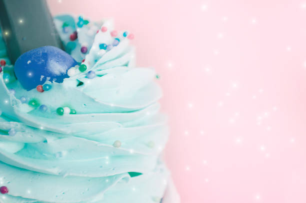 istock blue cream on the cake close-up, on a pink background 1149062295