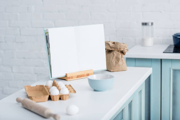 istock blank opened cookbook on table with cooking utensils and bakery ingredients 1149062322