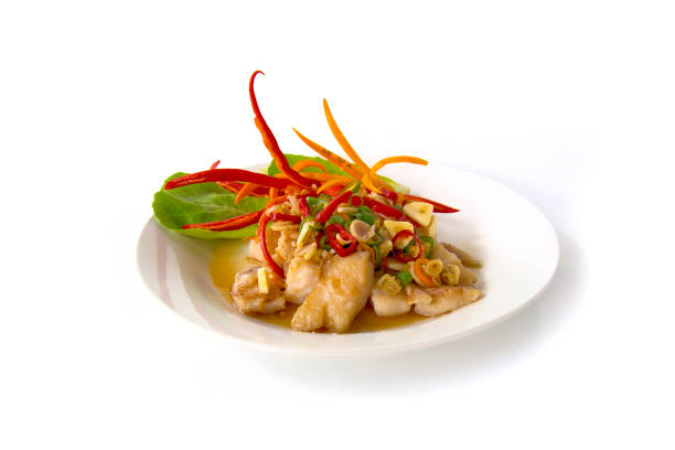 Grill Pangasius dory fish with tamarine sauce and slice fresh lemon grass, mix chilli three colours.Food for healthy or dietfood Isolated on white background