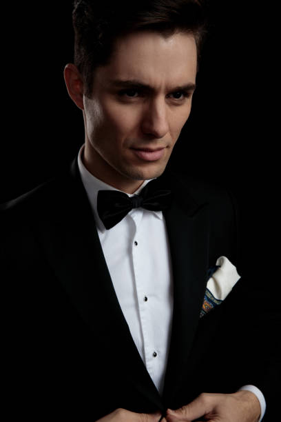 istock sexy gentleman buttoning his lounge jacket while looking away 1149066281