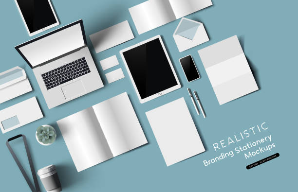 Top View Office Stationery And Objects Mockup Top down view of office desk realistic stationery and objects. Vector mockup illustration. business cards and stationery stock illustrations