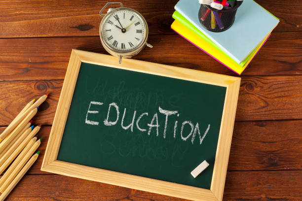 istock School supplies on a wooden table and blackboard 1149067749