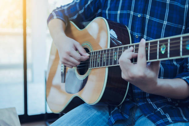 istock close up  of a man playing guitar 1149069651