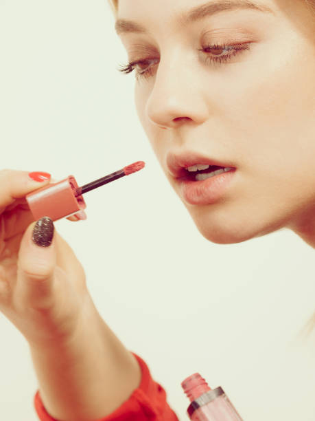 istock Woman applying lipstick or lip gloss 1149069749