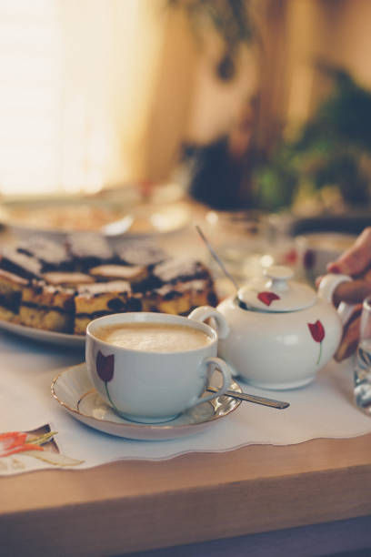 istock Warm coffee in a cup and cake on the table. Retro stylized photo. 1149071157