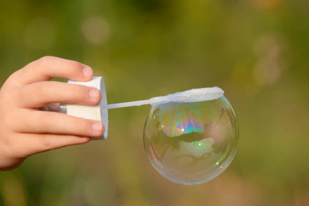 Soap bubble in the frame on children's hands