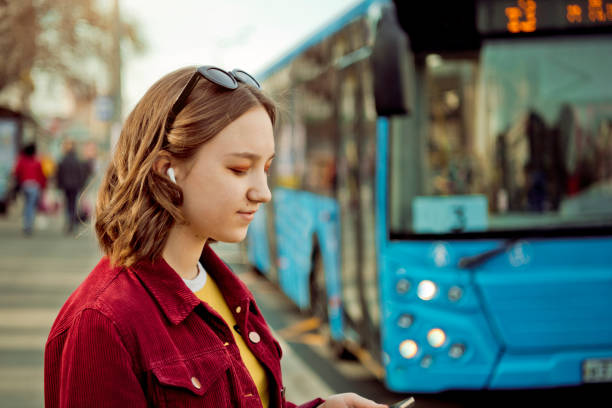 バスを待っている十代の少女 - female mobility blank teenage girls ストックフォトと画像