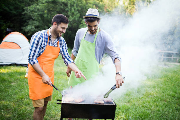 istock Friends having a barbecue party in nature 1149074140