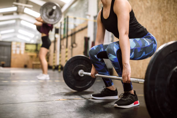 istock Young woman Preparing for Weightlifting 1149074146
