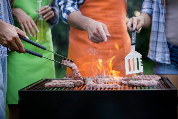 istock Handsome male preparing barbecue outdoors for friends 1149074254