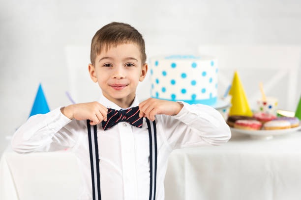 Happy boy with party hat on a party in the garden