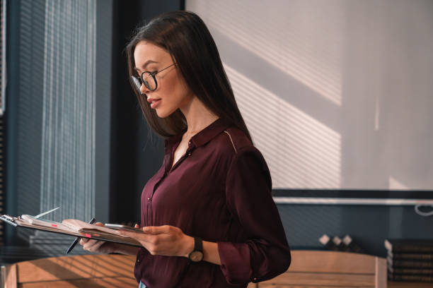 istock Confident young woman in office 1149076203