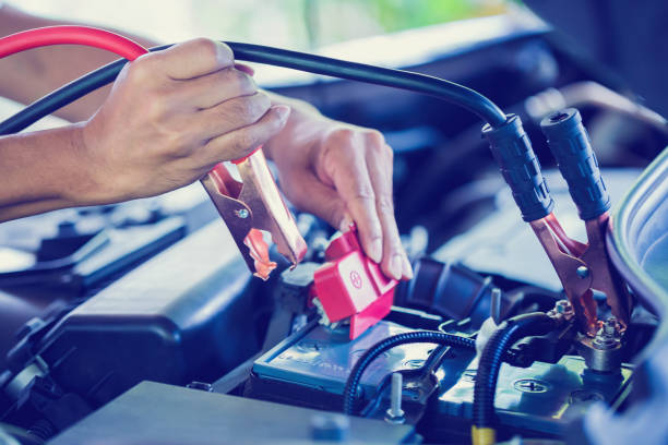 istock selective focus charging car with electricity trough cables 1149076455