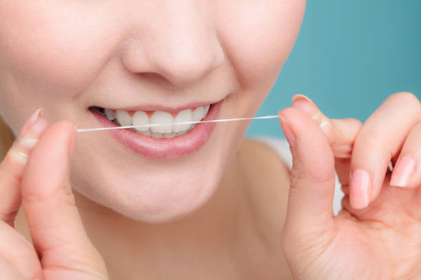 istock Woman smiling with dental floss. 1149077805