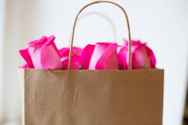 roses in brown shopping bag with handles