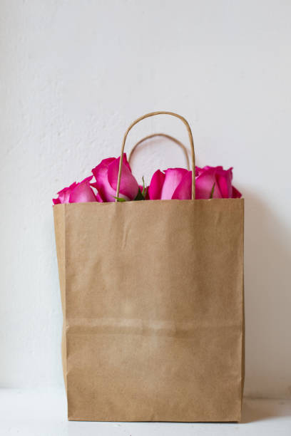 istock rose in brown shopping bag 1149078880