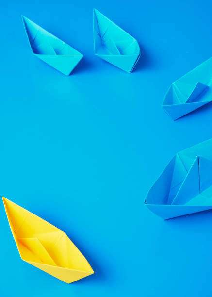 istock Yellow and Blue paper ship on blue background. Business for innovative solution concept 1149079192