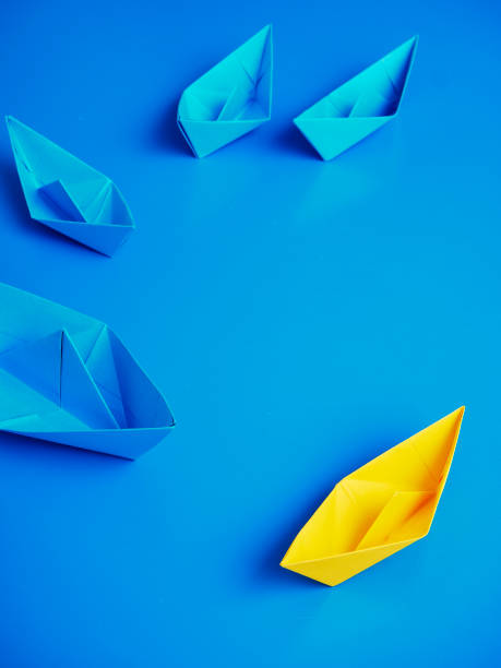 istock Yellow and Blue paper ship on blue background. Business for innovative solution concept 1149079193