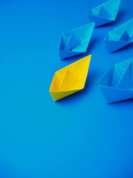 istock Yellow and Blue paper ship on blue background. Business for innovative solution concept 1149079223