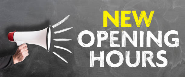 istock hand holding megaphone against chalkboard with text NEW OPENING HOURS 1149080441