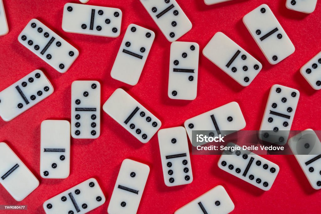 Domino game the domino game pieces on a red colored surface Domino Stock Photo