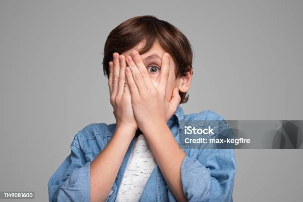 Scared Boy Covering Face Stock Photo - Download Image Now - Child, Boys, Fear