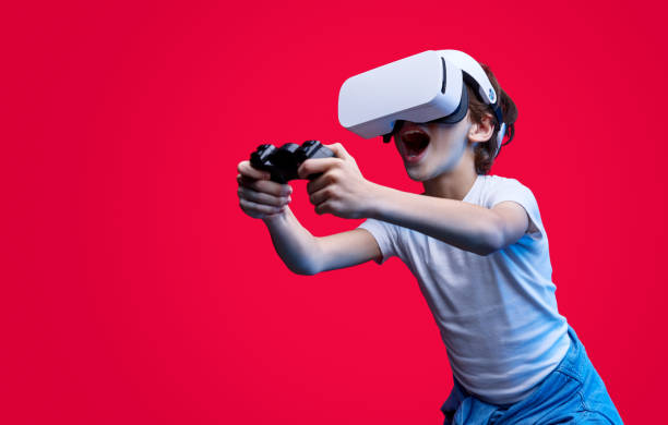 Expressive kid playing videogame in VR glasses