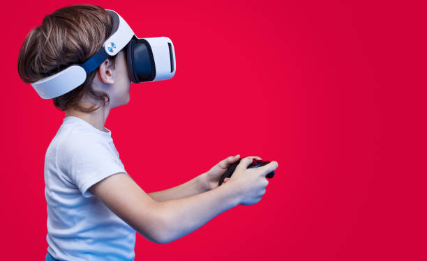 istock Playful boy in VR goggles and with gamepad 1149081643