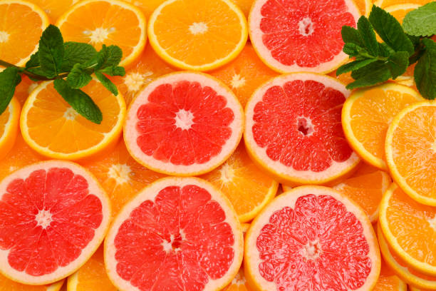 istock Slices of oranges and a grapefruits and mint as a background. 1149082239