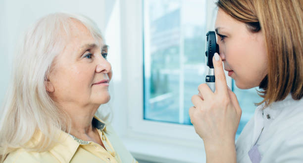 istock Senior woman doing eye test with eye equipment 1149082314