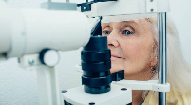 istock Senior woman doing eye test with eye equipment 1149082322