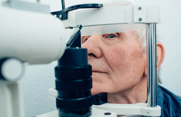 istock Senior man getting eye exam at clinic, close-up 1149082404