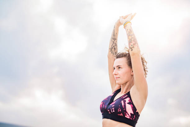 istock Sporty young tattooed woman stretching. 1149082433