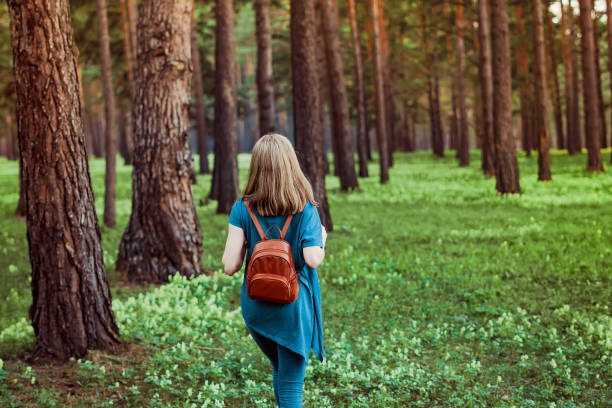 istock girl walking in the woods 1149083461